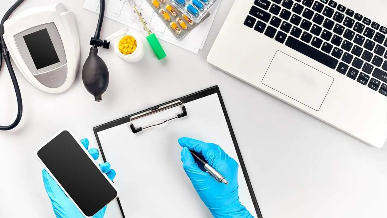 Doctor s table, tools, medical instruments, therapist tonometer, blood pressure, work in hospital on white background flat lay. The doctor's hand in a blue glove records the indicators on a white paper blank. Top view. Still life. Copy space