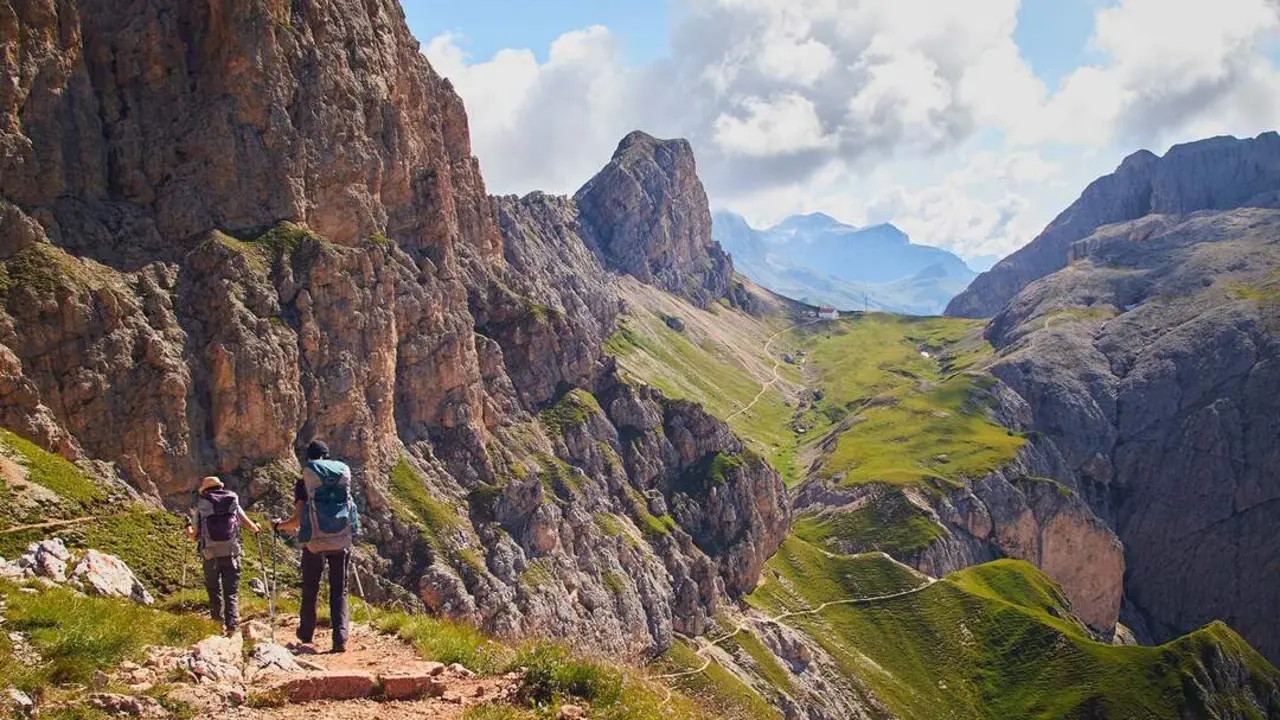 A group of people hiking in the mountains of Schlern-Rosengarten Nature Park  in Italy
